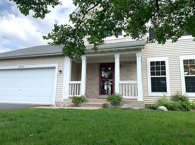 1453 Bluestem Ln, Minooka, IL 60447 - view of front of house featuring a front lawn, driveway, a porch, a garage, and brick siding
