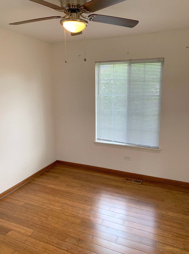 1453 Bluestem Ln, Minooka, IL 60447 - unfurnished room featuring ceiling fan, wood-type flooring, and baseboards