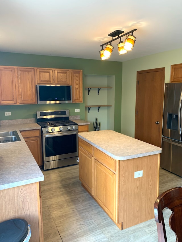 1453 Bluestem Ln, Minooka, IL 60447 - kitchen featuring stainless steel appliances, light countertops, a sink, and a center island