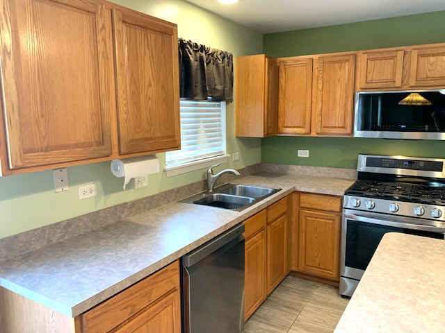 1453 Bluestem Ln, Minooka, IL 60447 - kitchen with appliances with stainless steel finishes, a sink, and light countertops
