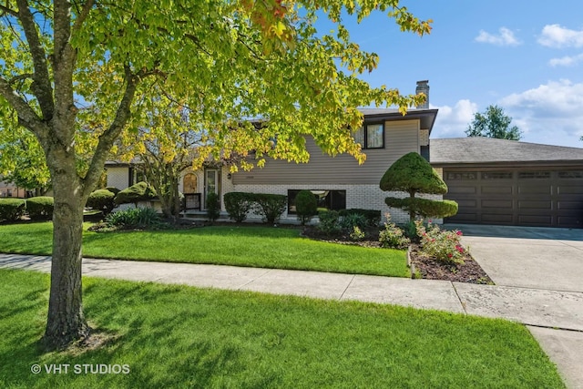 17000 Cherry Creek Ave, Tinley Park, IL 60487 - split level home with driveway, a front lawn, a garage, brick siding, and a chimney