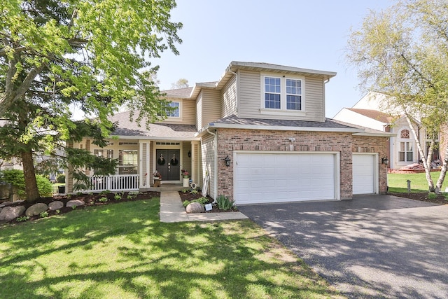 view of front of home featuring asphalt driveway, a porch, a front lawn, and brick siding