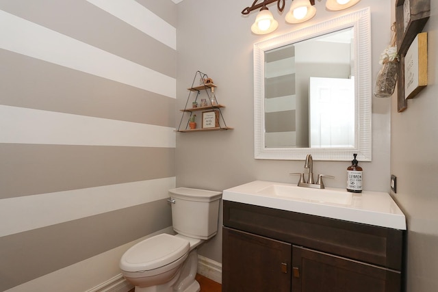 half bath featuring toilet and vanity