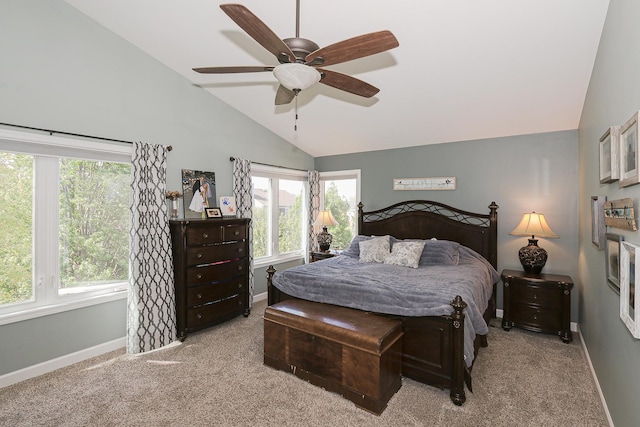 bedroom featuring lofted ceiling, baseboards, carpet flooring, and multiple windows