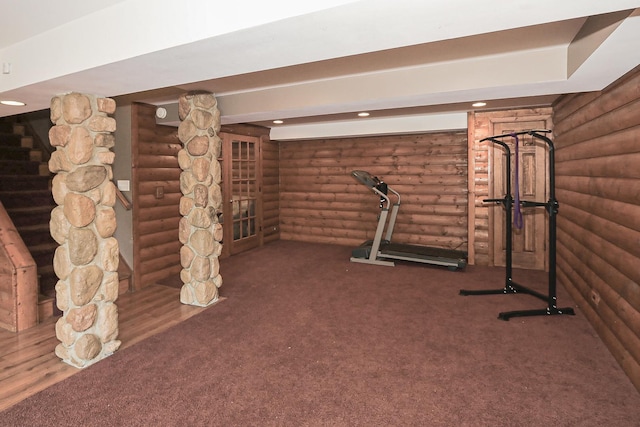 exercise area featuring rustic walls, carpet flooring, and recessed lighting