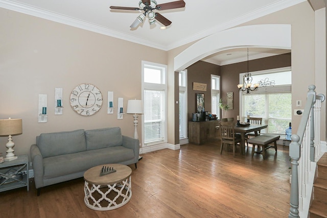 living area featuring arched walkways, wood finished floors, ceiling fan, plenty of natural light, and crown molding