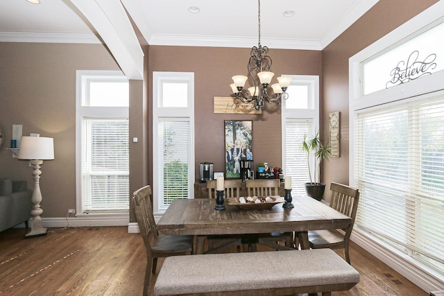dining area featuring wood finished floors, a chandelier, baseboards, arched walkways, and crown molding