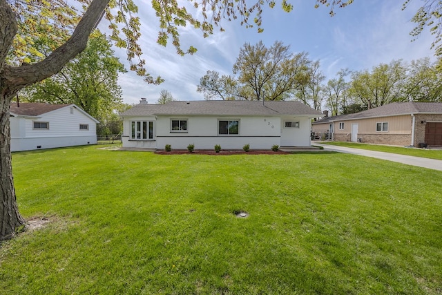 back of property with a lawn and a chimney