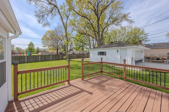 wooden deck with a garage and an outbuilding