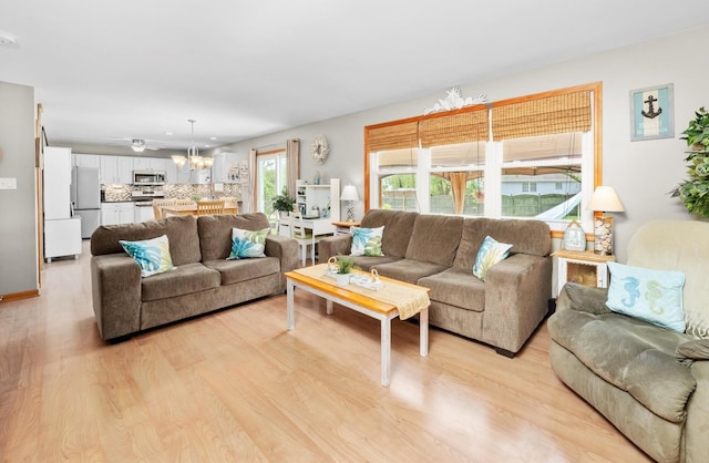 5157 Ribbon Ct, Monee, IL 60449 - living area featuring light wood-style flooring and a chandelier