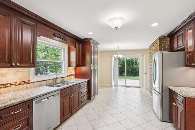 kitchen featuring stainless steel appliances, a sink, tasteful backsplash, a chandelier, and recessed lighting