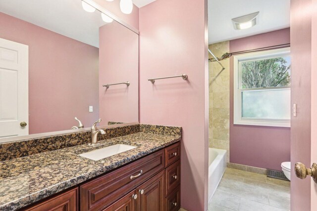 full bath with toilet, vanity, tile patterned floors, and bathing tub / shower combination