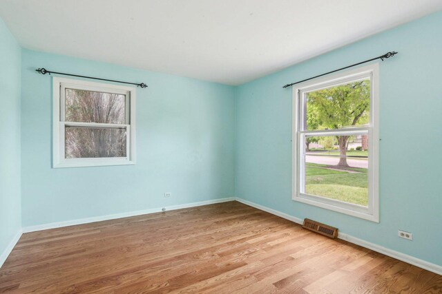 empty room with light wood-style floors and baseboards