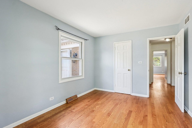 unfurnished bedroom featuring light wood-type flooring and baseboards