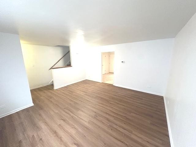 2209 171st St, Hazel Crest, IL 60429 - unfurnished living room featuring wood finished floors, baseboards, and stairway