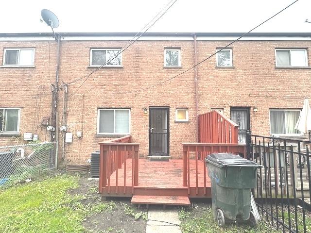 2209 171st St, Hazel Crest, IL 60429 - back of property featuring fence, central AC, a wooden deck, and brick siding