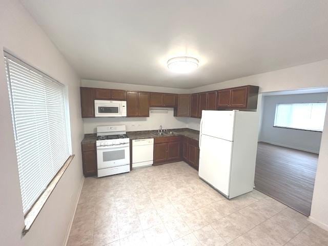2209 171st St, Hazel Crest, IL 60429 - kitchen featuring white appliances, baseboards, dark countertops, a sink, and dark brown cabinetry