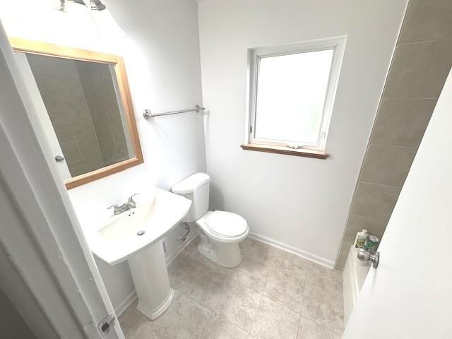 2209 171st St, Hazel Crest, IL 60429 - bathroom featuring toilet, baseboards, and tile patterned flooring