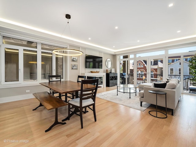 dining space with light wood finished floors, baseboards, and recessed lighting