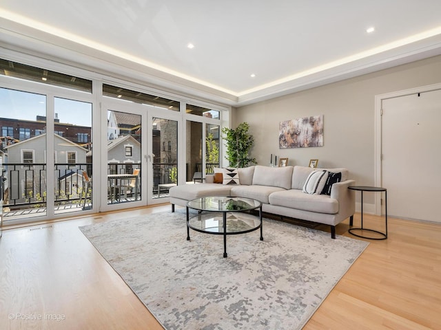 living area with wood finished floors, healthy amount of natural light, and recessed lighting
