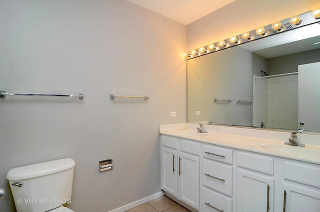 bathroom with toilet, a shower, double vanity, tile patterned flooring, and baseboards