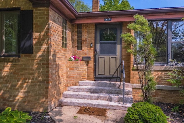 315 W Bennett St, Pontiac, IL 61764 - doorway to property with brick siding and a chimney
