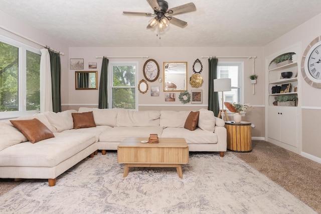 315 W Bennett St, Pontiac, IL 61764 - carpeted living room featuring healthy amount of natural light, a ceiling fan, built in features, a textured ceiling, and baseboards