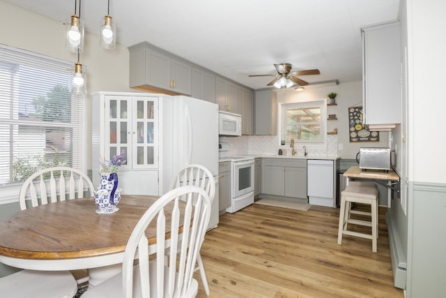315 W Bennett St, Pontiac, IL 61764 - kitchen featuring white appliances, gray cabinetry, ceiling fan, decorative backsplash, and light wood-type flooring