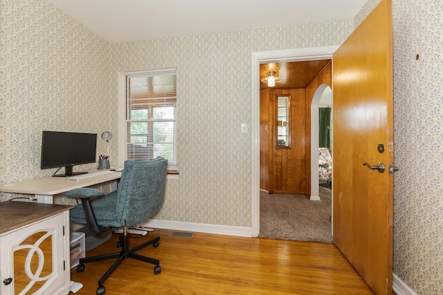 315 W Bennett St, Pontiac, IL 61764 - office area featuring wood finished floors, arched walkways, wallpapered walls, and baseboards