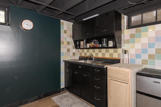 315 W Bennett St, Pontiac, IL 61764 - kitchen with a sink, open shelves, wood finished floors, backsplash, and dark countertops