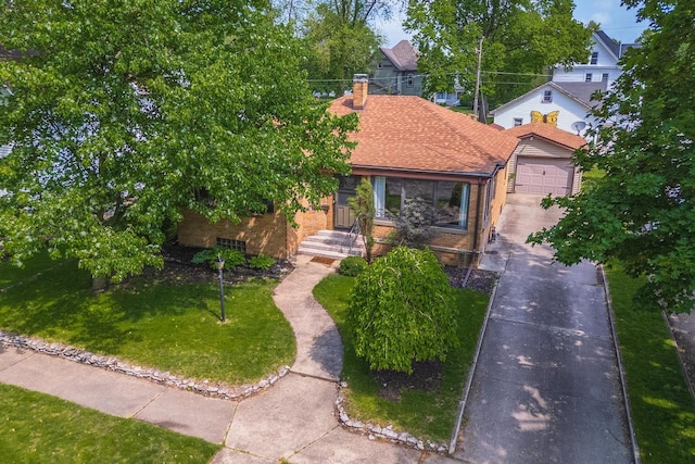 315 W Bennett St, Pontiac, IL 61764 - view of front of house featuring concrete driveway, brick siding, a garage, a chimney, and a shingled roof