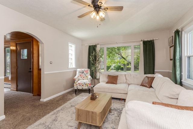 315 W Bennett St, Pontiac, IL 61764 - living area featuring arched walkways, light colored carpet, baseboards, a ceiling fan, and a baseboard heating unit