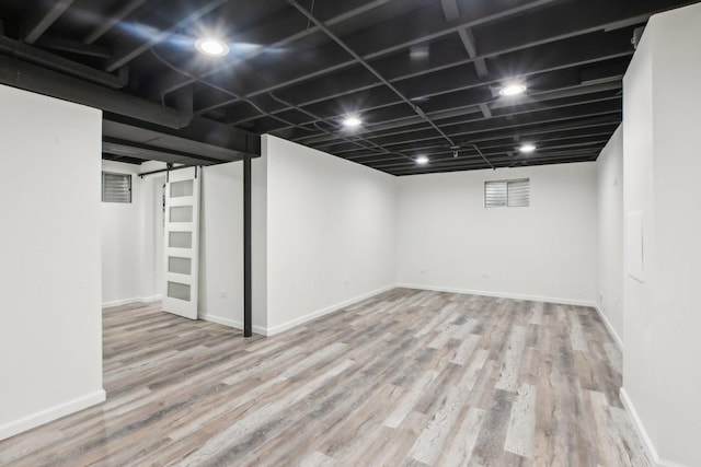 finished basement with wood finished floors and baseboards