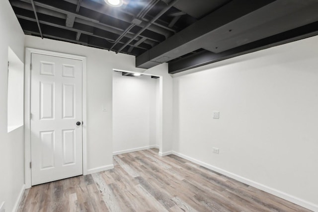 finished basement featuring wood finished floors and baseboards