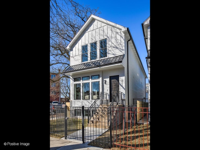 1727 W Barry Ave, Chicago, IL 60657 - view of front of home featuring board and batten siding, a gate, a fenced front yard, metal roof, and a standing seam roof