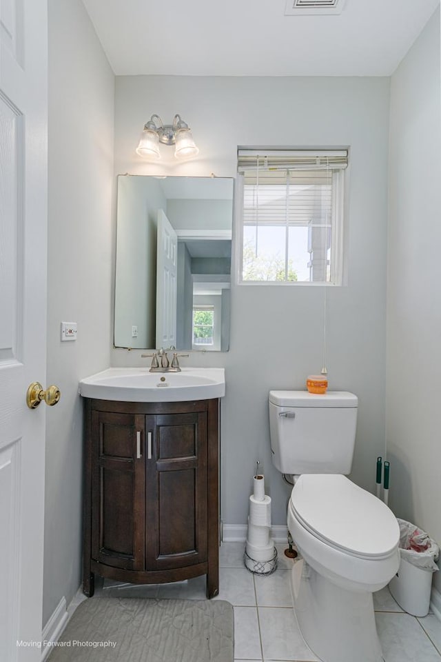 13 Caribou Ct, Bolingbrook, IL 60490 - half bathroom featuring toilet, vanity, tile patterned floors, and baseboards