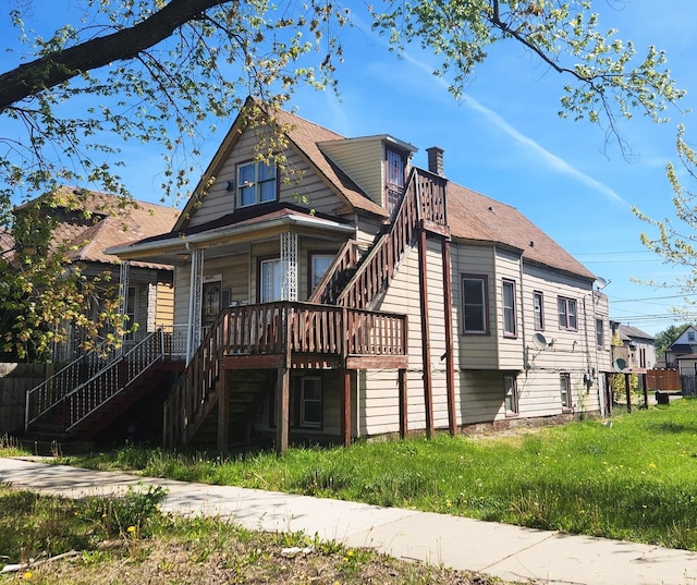 10435 S Calhoun Ave, Chicago, IL 60617 - back of house featuring stairway and a chimney
