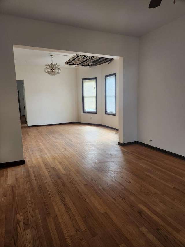 10435 S Calhoun Ave, Chicago, IL 60617 - unfurnished room with wood finished floors, a chandelier, baseboards, and ceiling fan