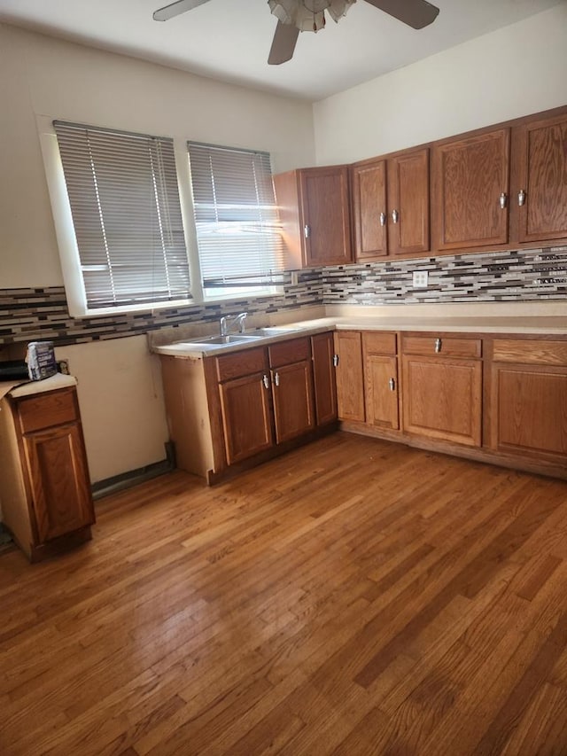 10435 S Calhoun Ave, Chicago, IL 60617 - kitchen featuring ceiling fan, decorative backsplash, and light countertops
