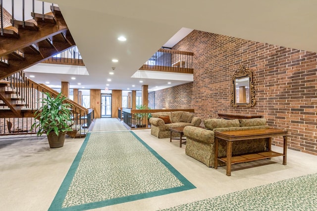 1401 Burr Oak Rd Unit 314B, Hinsdale, IL 60521 - common area with a towering ceiling, brick wall, stairway, and recessed lighting