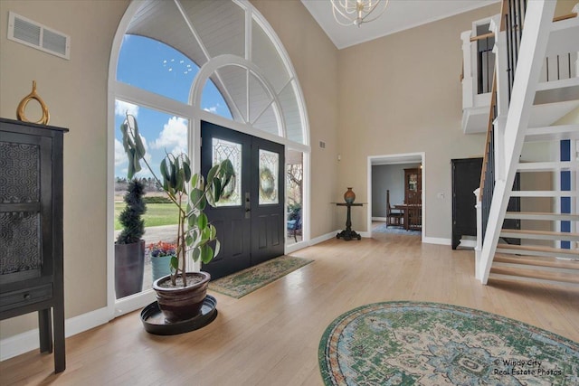 1375 Atkinson Rd, Green Oaks, IL 60048 - foyer entrance featuring a towering ceiling, wood finished floors, stairway, baseboards, and a chandelier