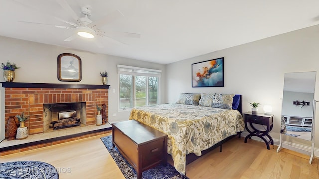 1375 Atkinson Rd, Green Oaks, IL 60048 - bedroom featuring wood finished floors, access to exterior, a brick fireplace, ceiling fan, and baseboards
