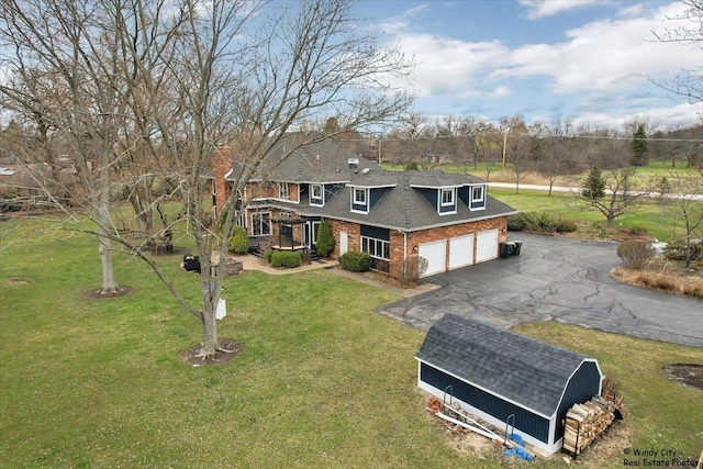 1375 Atkinson Rd, Green Oaks, IL 60048 - view of front of house with a chimney, brick siding, a front yard, and driveway