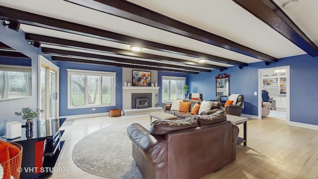 1375 Atkinson Rd, Green Oaks, IL 60048 - living area featuring baseboards, a glass covered fireplace, beam ceiling, and wood finished floors