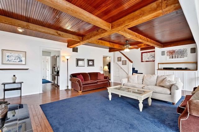 living room featuring wood ceiling, beam ceiling, stairs, hardwood / wood-style flooring, and ceiling fan