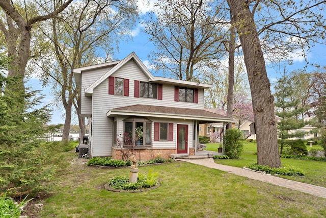 traditional home with a front lawn and brick siding