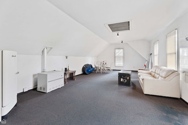 bonus room with lofted ceiling and carpet