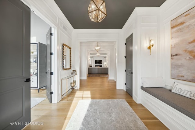 1110 Hickory Dr, Western Springs, IL 60558 - corridor featuring light wood-style floors and a chandelier