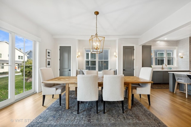 1110 Hickory Dr, Western Springs, IL 60558 - dining space featuring a chandelier, light wood-style flooring, and healthy amount of natural light