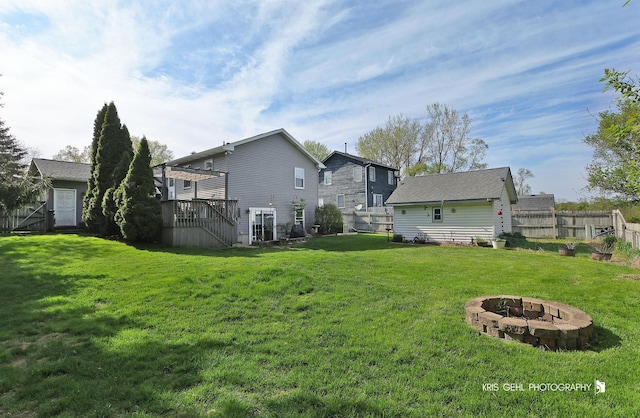 1204 Capri Ter, Mchenry, IL 60050 - rear view of house with a fire pit, stairway, and a wooden deck